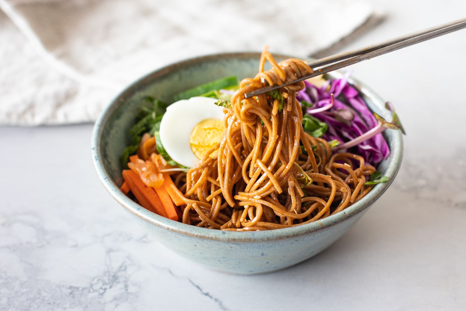 Bibim Guksu (Korean Spicy Cold Noodles) Picked up with Chopped Sticks