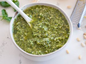 Scallion pesto in white bowl with white spoon