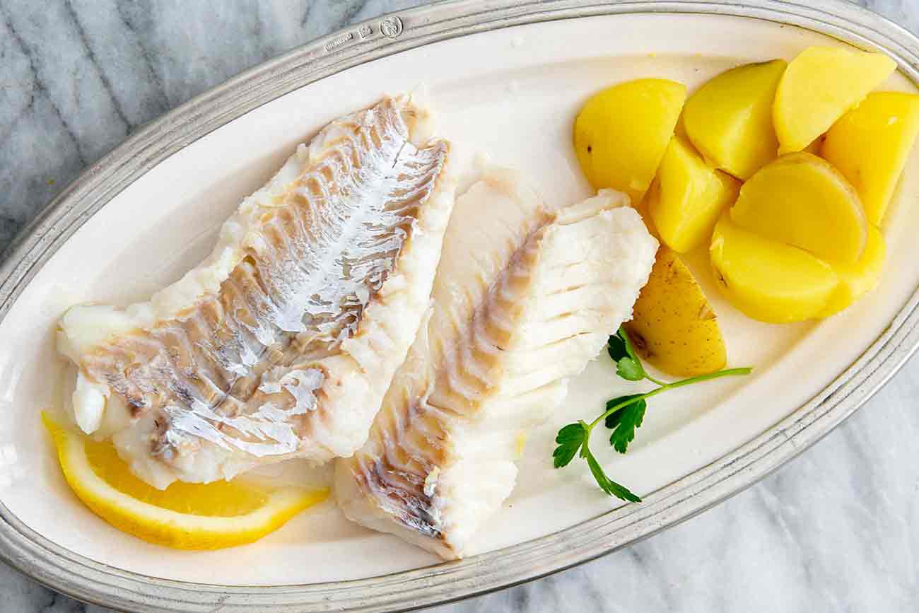 white fish with boiled potatoes on the side