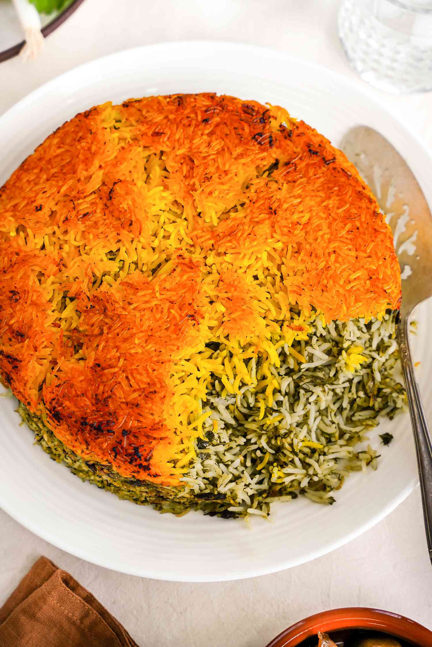 Sabzi Polo (Persian Herb Rice) on a Plate With a Serving Spoon 
