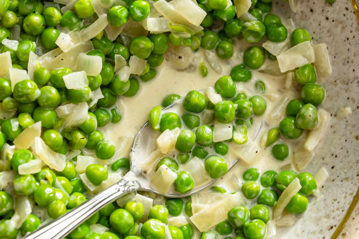 Creamed Peas in a dish with a spoon