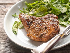 Easy Pork Chop Recipe pork chop and greens on plate