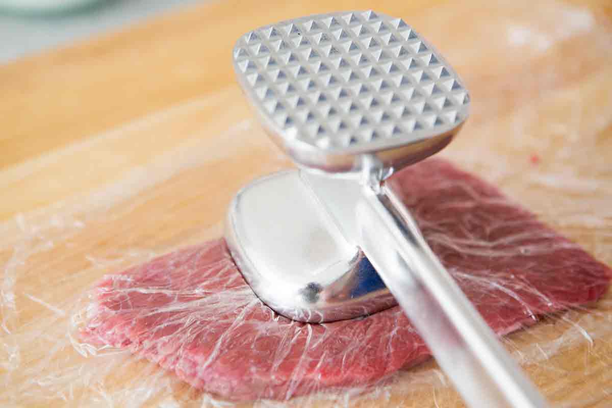 Preparing sirloin for chicken fried steak with meat hammer