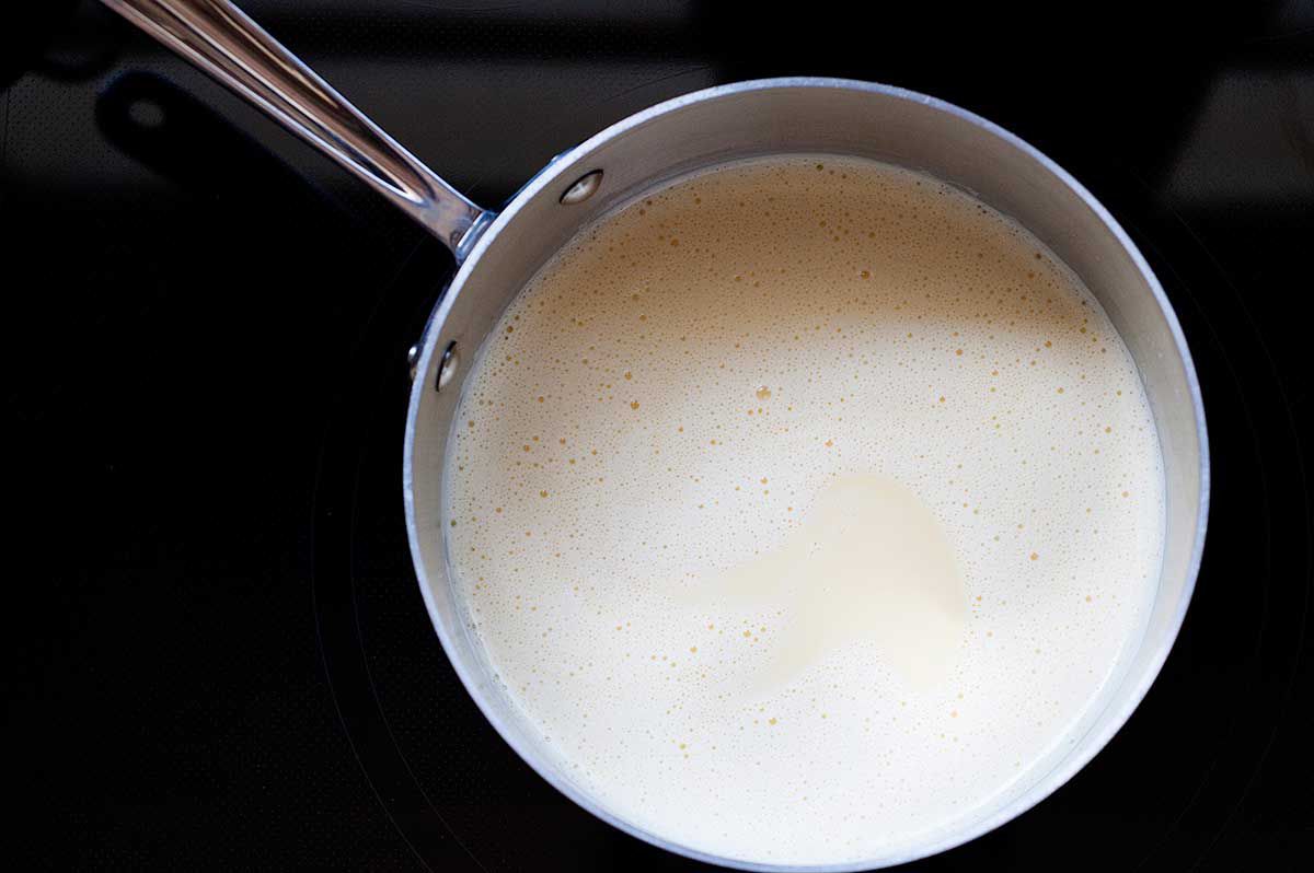 Vanilla Ice Cream with Chocolate and Marshmallows - custard in a pot on the stove