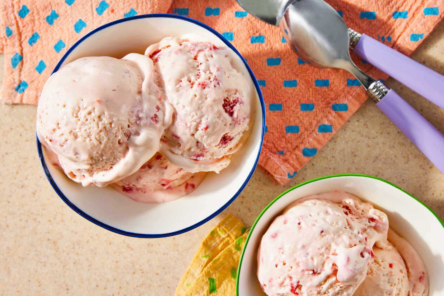 strawberry marlow in two bowls next to table napkins and spoons