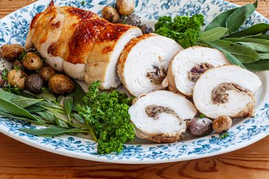 Turkey breast stuffed and sliced on a platter.