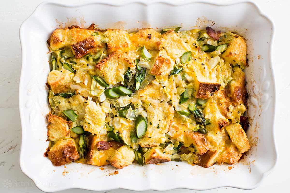 asparagus and artichoke casserole in a white baking dish