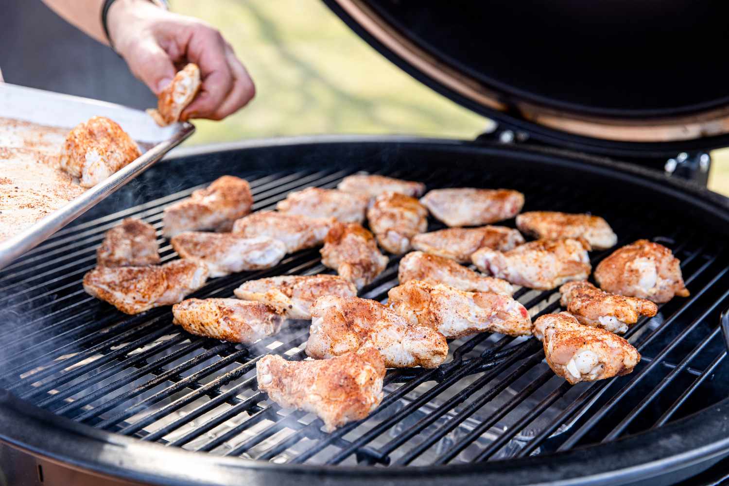 Seasoned Chicken Added to Outdoor Grill 