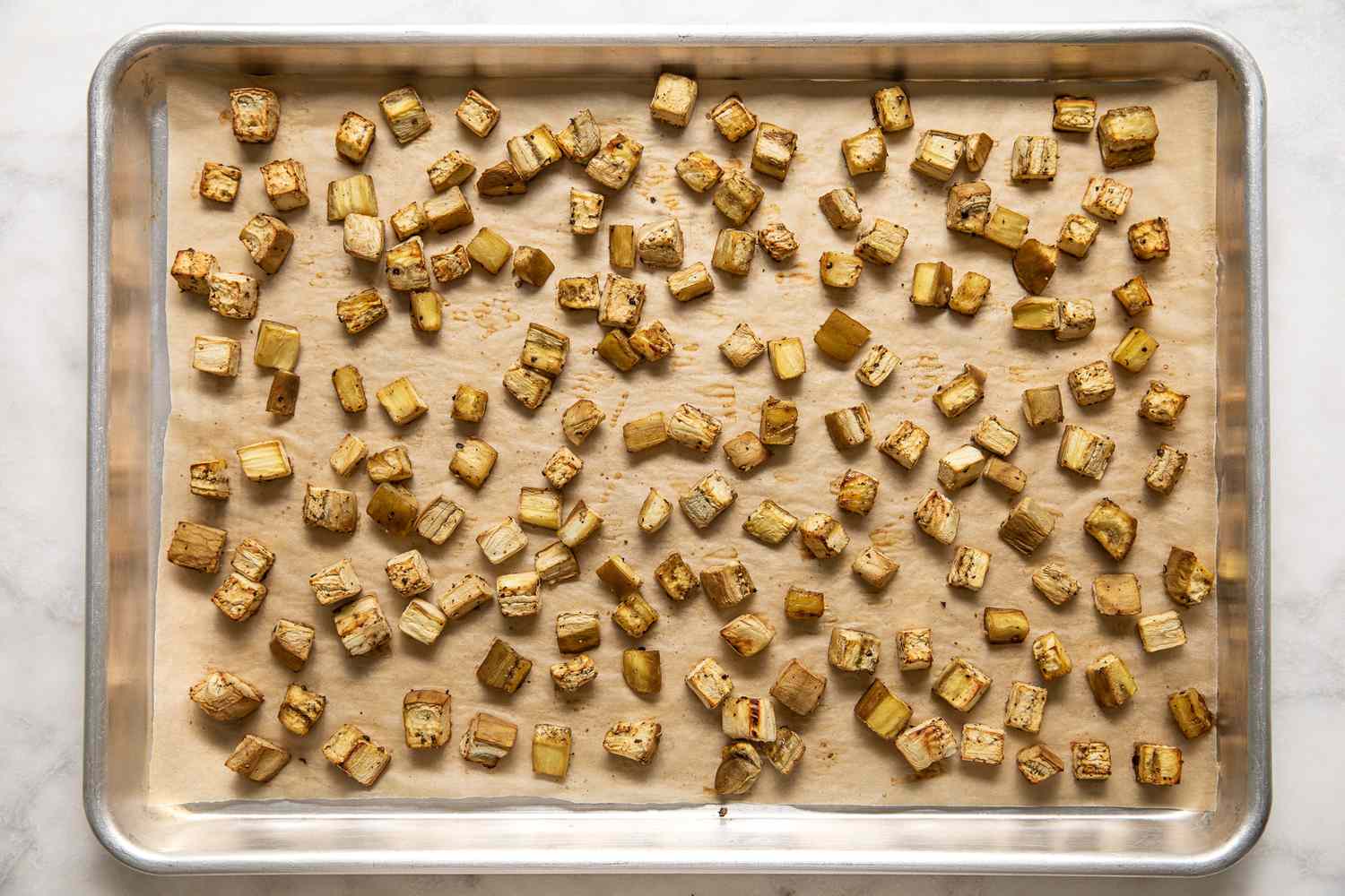 Roasted Cubed Eggplant on a Parchment Lined Baking Tray