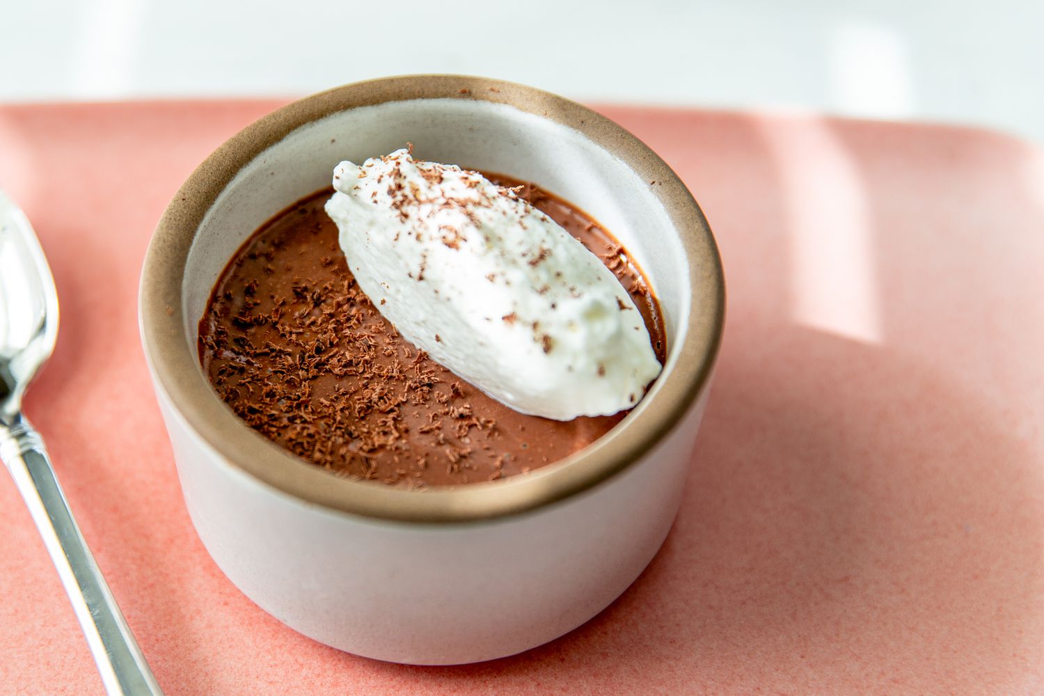 5-minute mousse in a cup with some whipped cream and shaved chocolate pieces