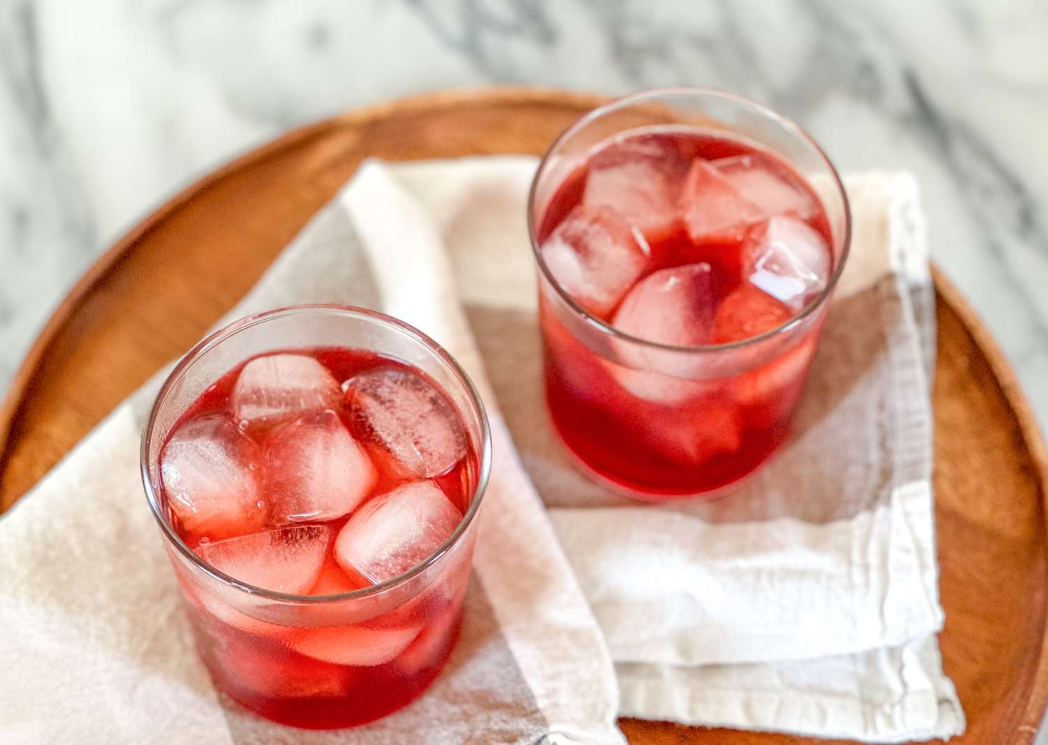 Herbal iced tea on a platter with a kitchen linen