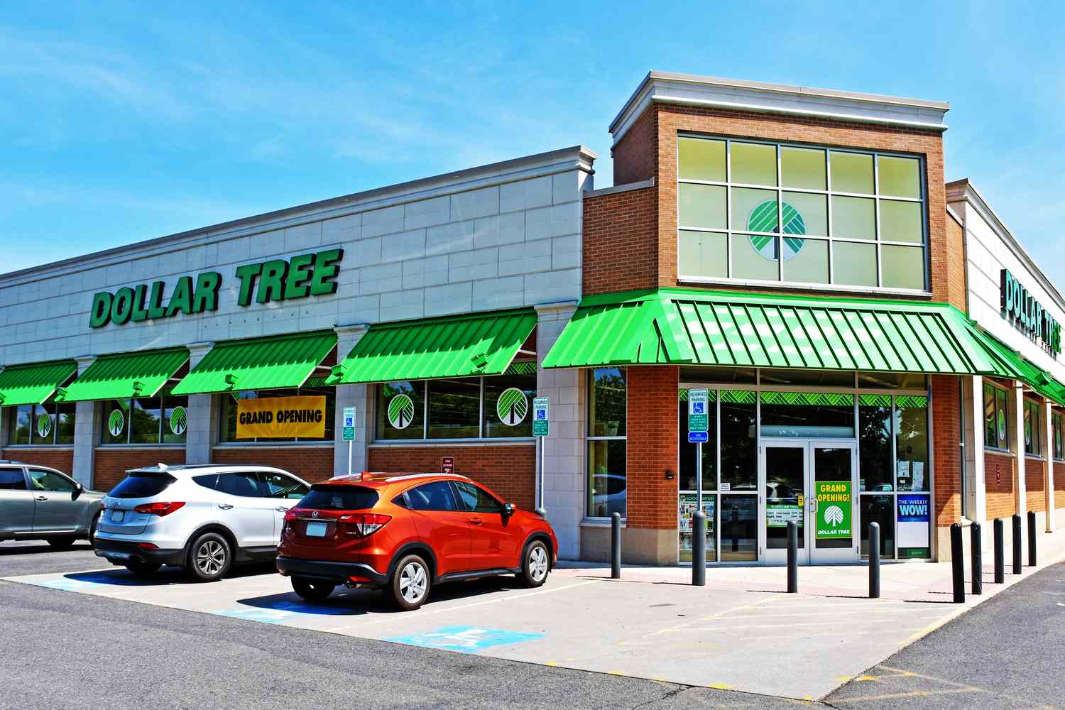 Exterior of a Dollar Tree store with parked cars in the parking lot