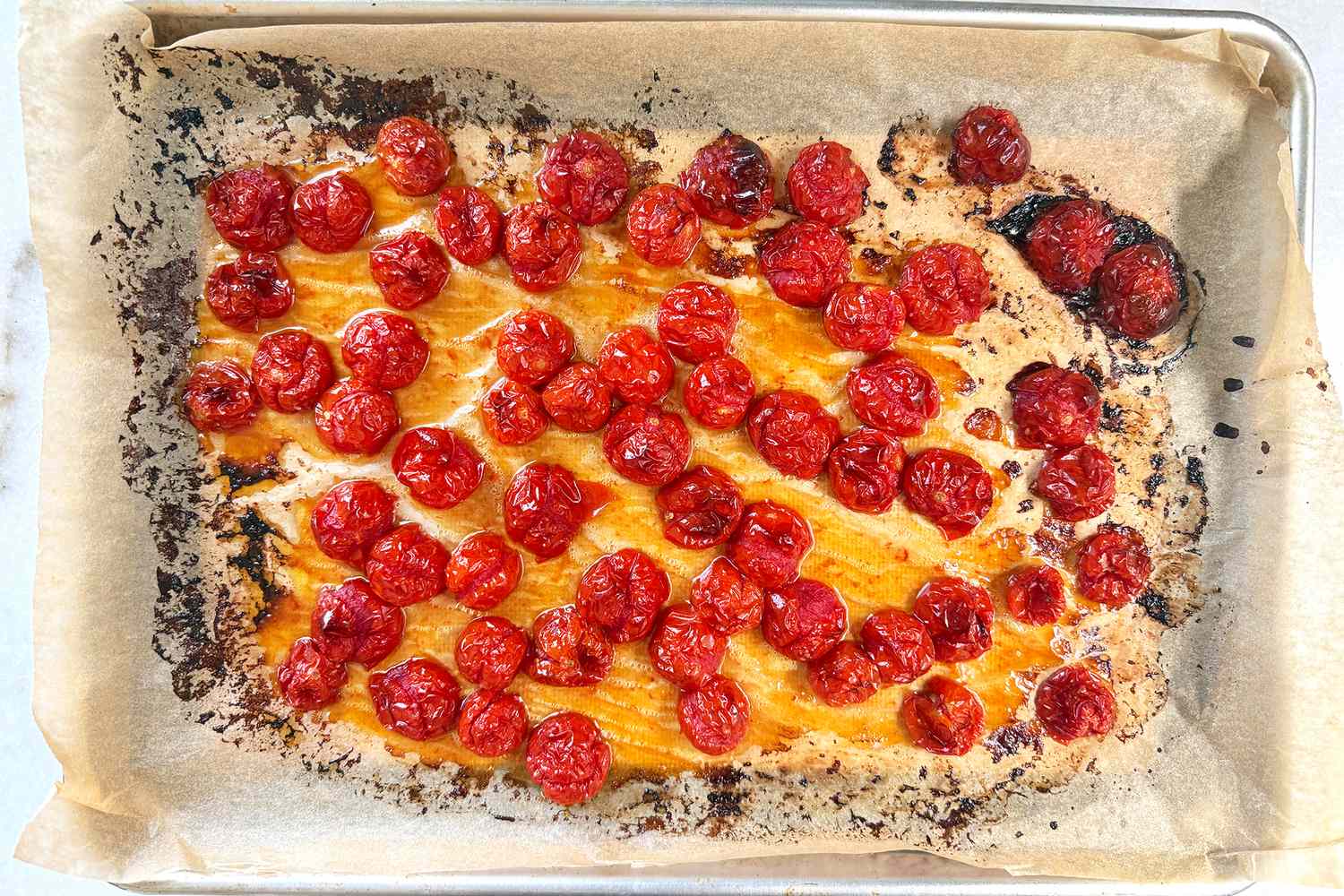 overhead view of a sheet-pan of roasted cherry tomatoes