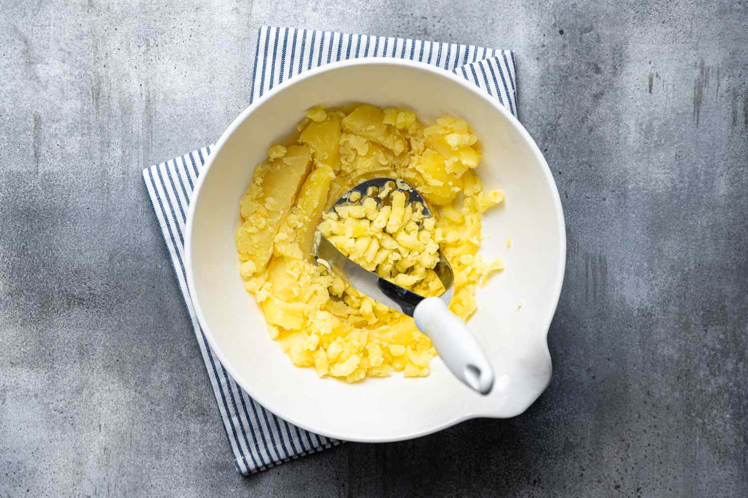 Mashed cooked potatoes in a bowl to make Cod Fish Cakes