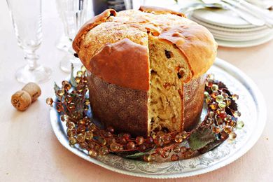 A round loaf of panettone with a slice removed