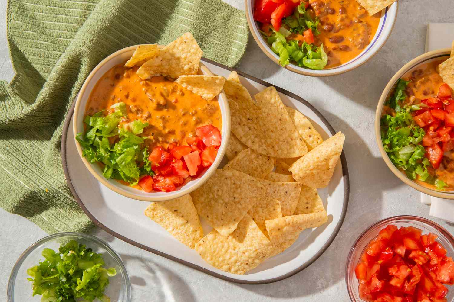 creamed tacos in bowl with chips, lettuce and tomatoes