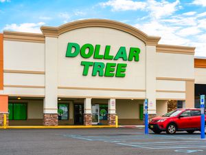 The exterior of a Dollar Tree store with a parked car