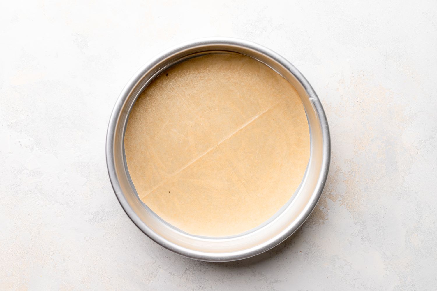 Round Cake Pan Lined with Parchment Paper for Flourless Chocolate Cake Recipe