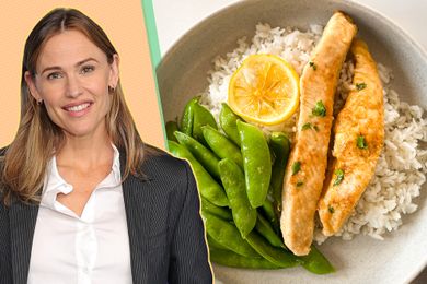 A woman smiling next to a dish of rice snap peas and fish filet