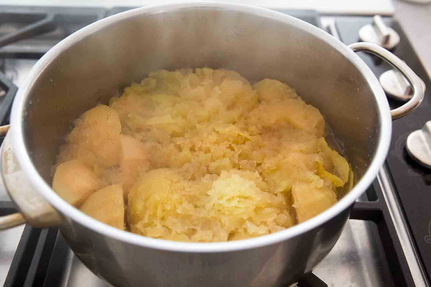 Homemade applesauce in a pot, ready to mash