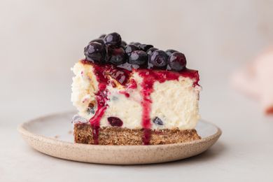 A slice of blueberry cheesecake on a plate.