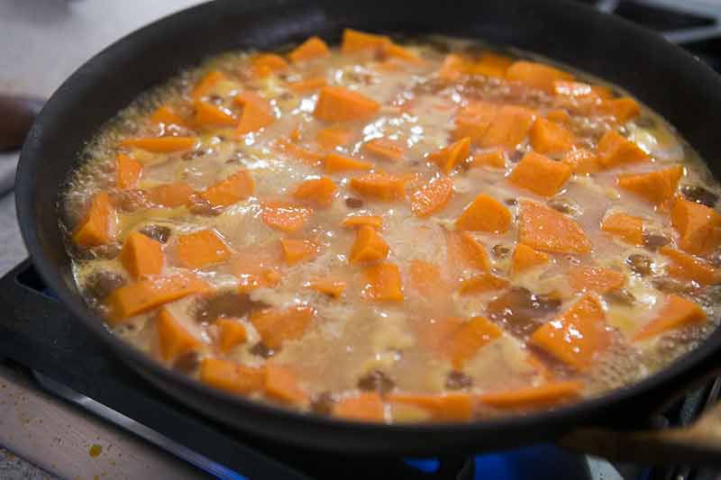 A skillet of simmering candied yams