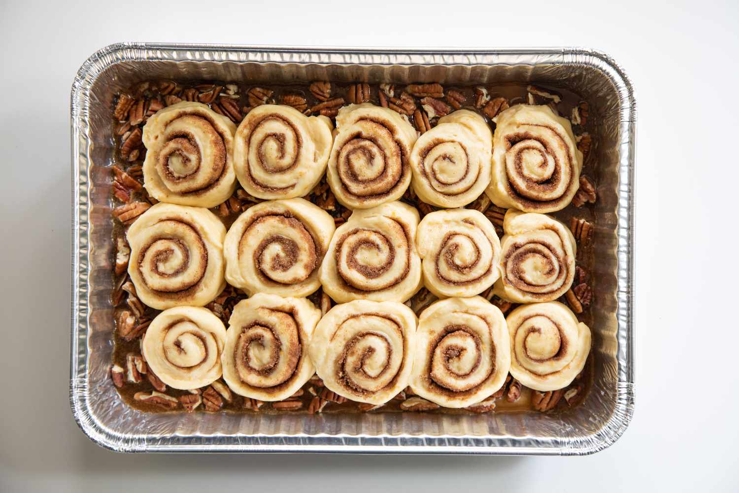 A pan of unbaked sticky buns recipe.