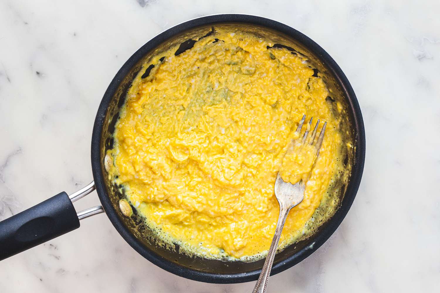 Lightly Scramble French Omelette Eggs in Pan with a Fork