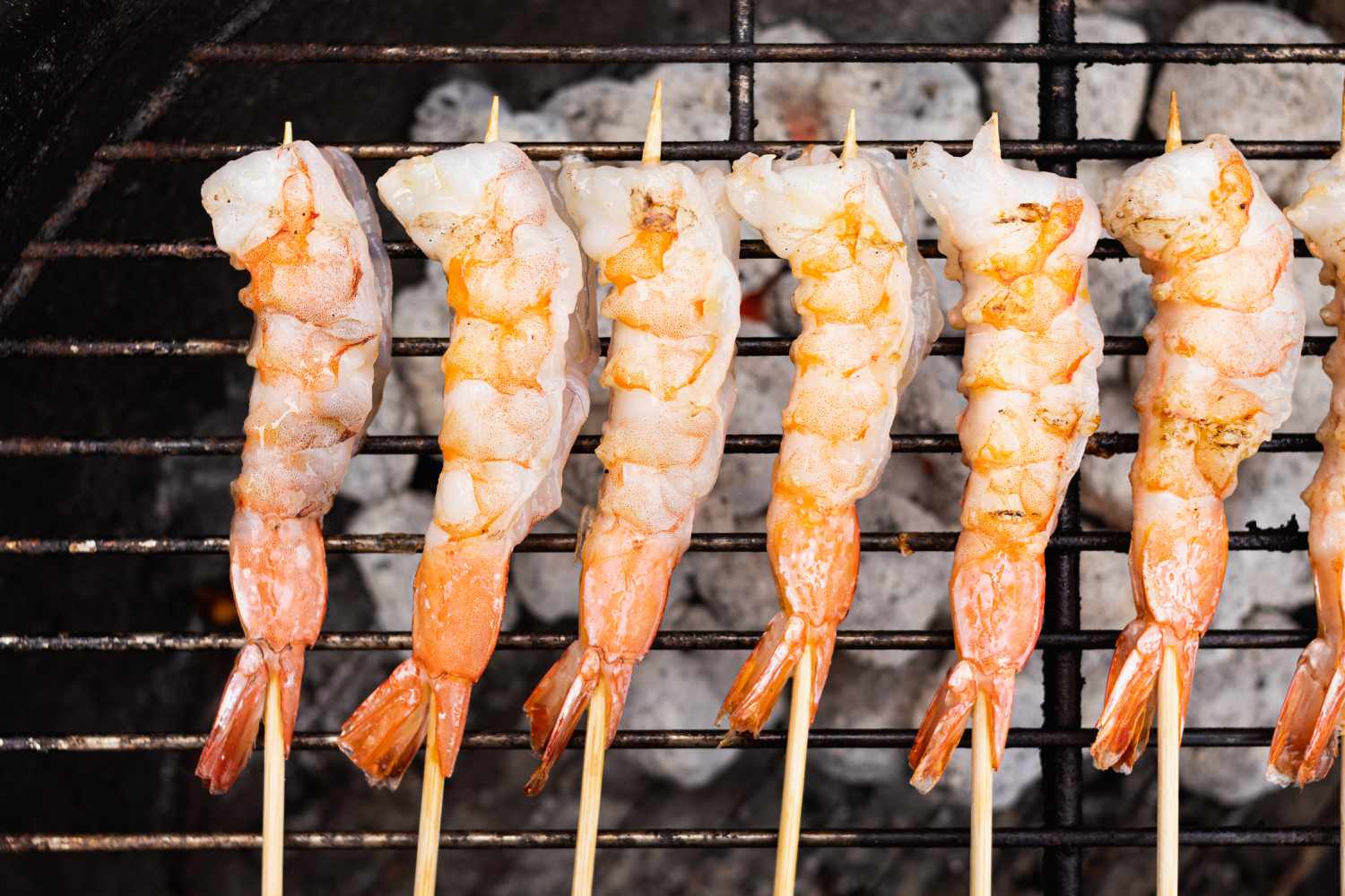 Overhead view of grilled shrimp skewers.