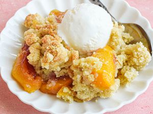 A Small Plate of Peach Cobbler Topped with a Scoop of Vanilla Ice Cream