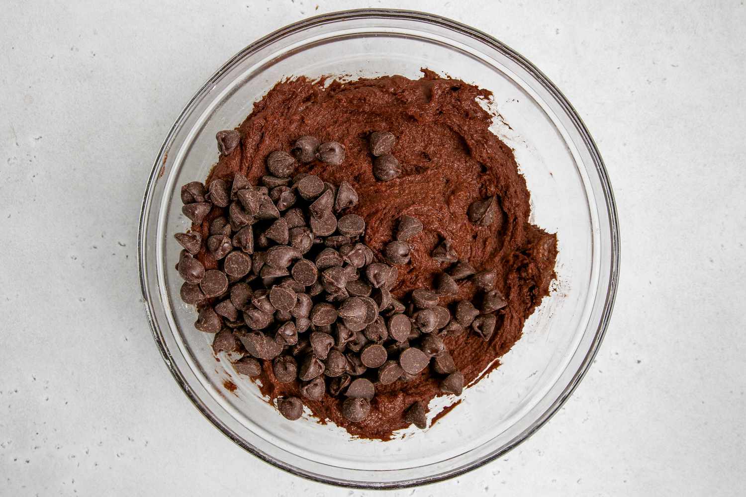Chocolate chips added to chocolate dough to make a chocolate chip chocolate recipe.