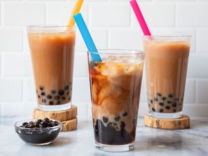 Three Glasses of Bubble Tea Next to a Bowl of Boba
