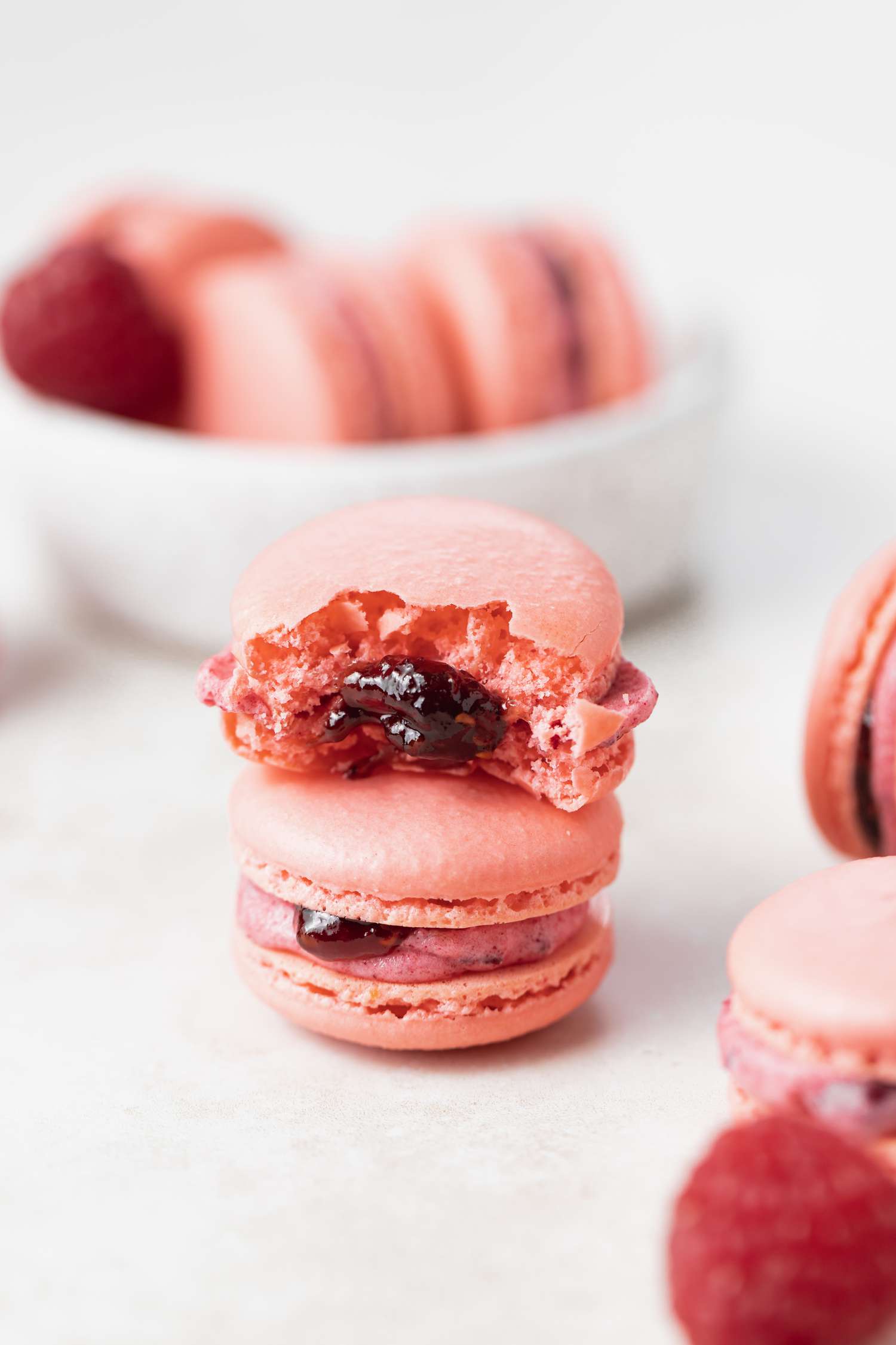 Side view of stacked macarons with raspberry filling