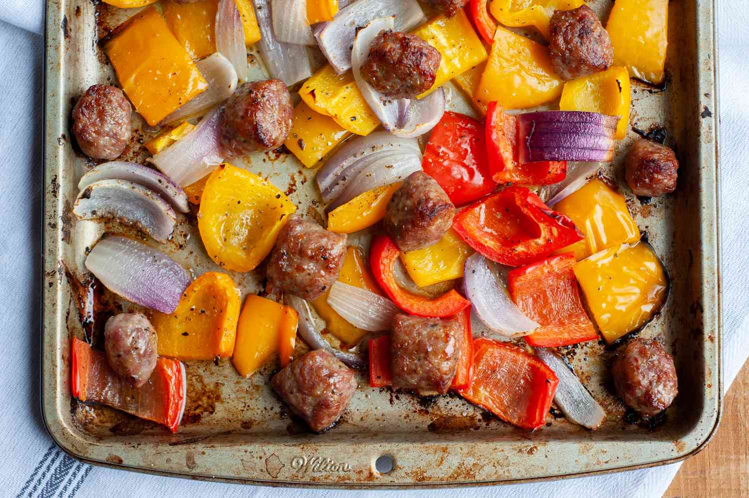 Overhead view of a sheet pan sausage dinner.