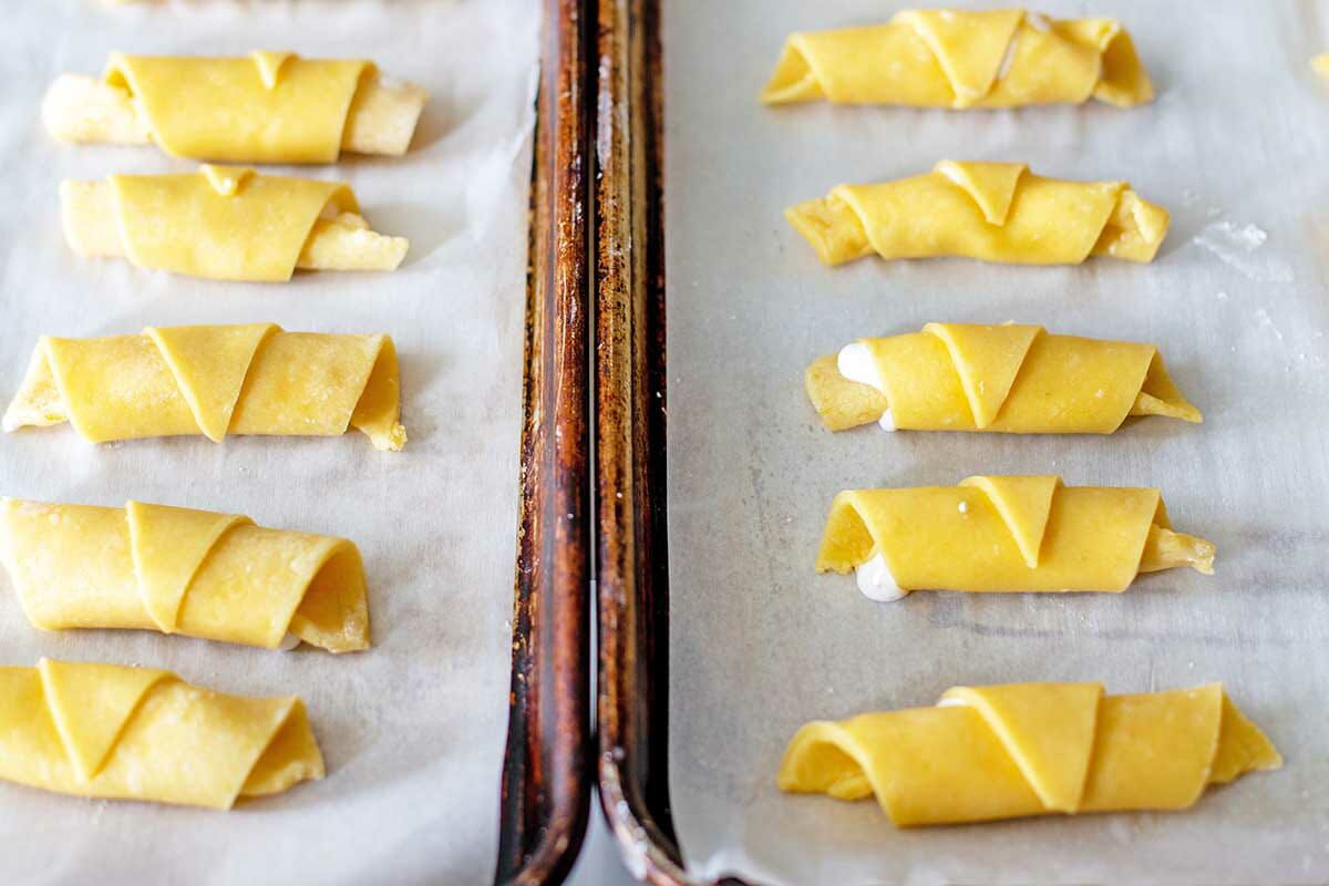 Flaky Butter Cookies shaped on parchment covered baking sheets.