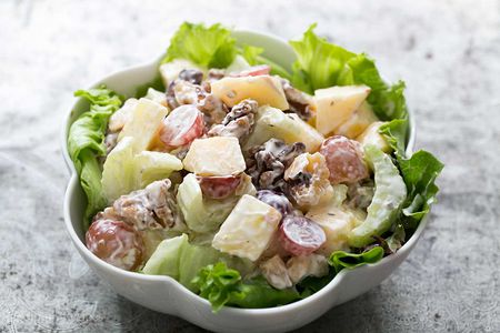 A Waldorf Salad in a scalloped white bowl