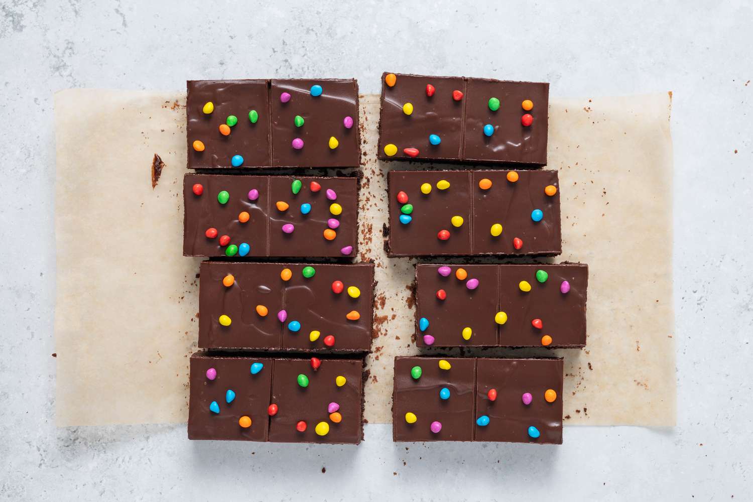 Homemade Cosmic Brownies (with signature perforated line) on a piece of parchment paper 