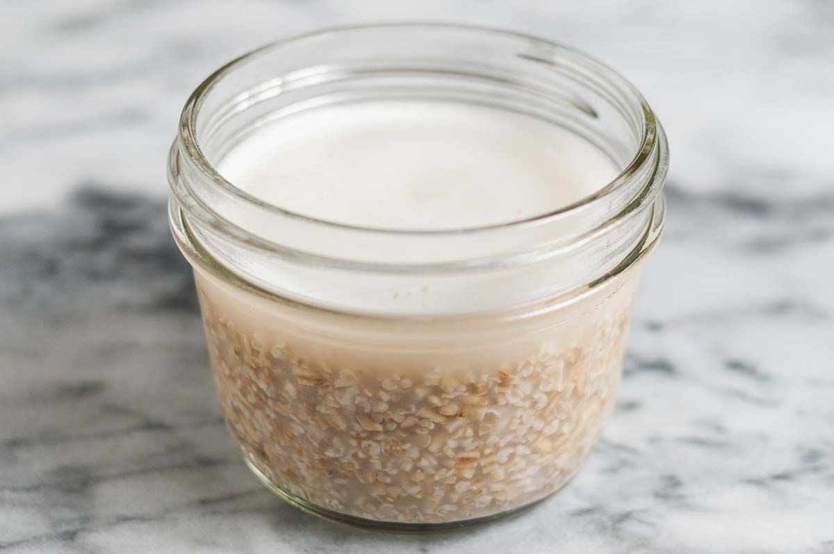 A jar of steel cut oats, standing after microwaving in order to thicken up