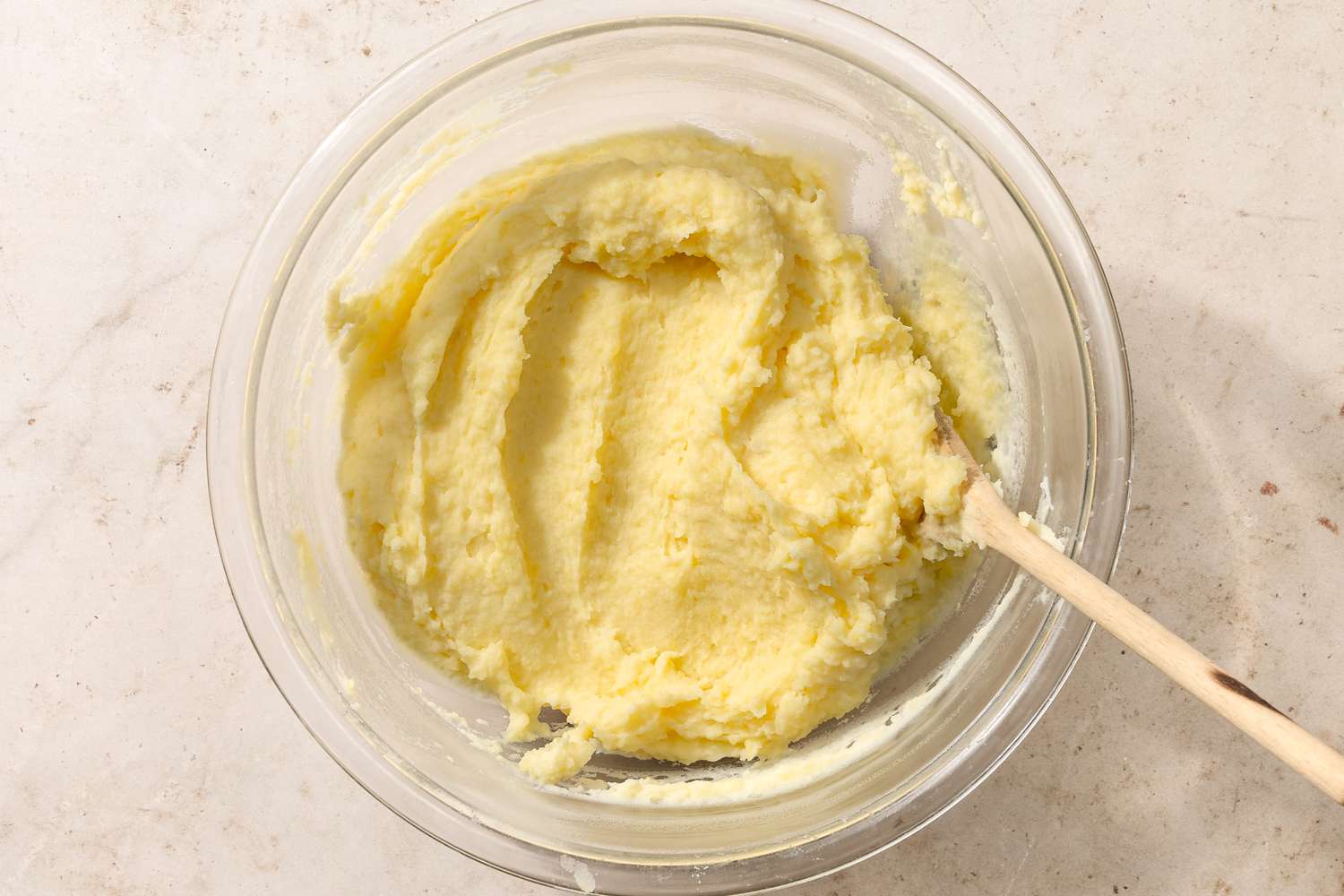 overhead view of potato puree in a bowl with a spoon for Chantilly Potatoes