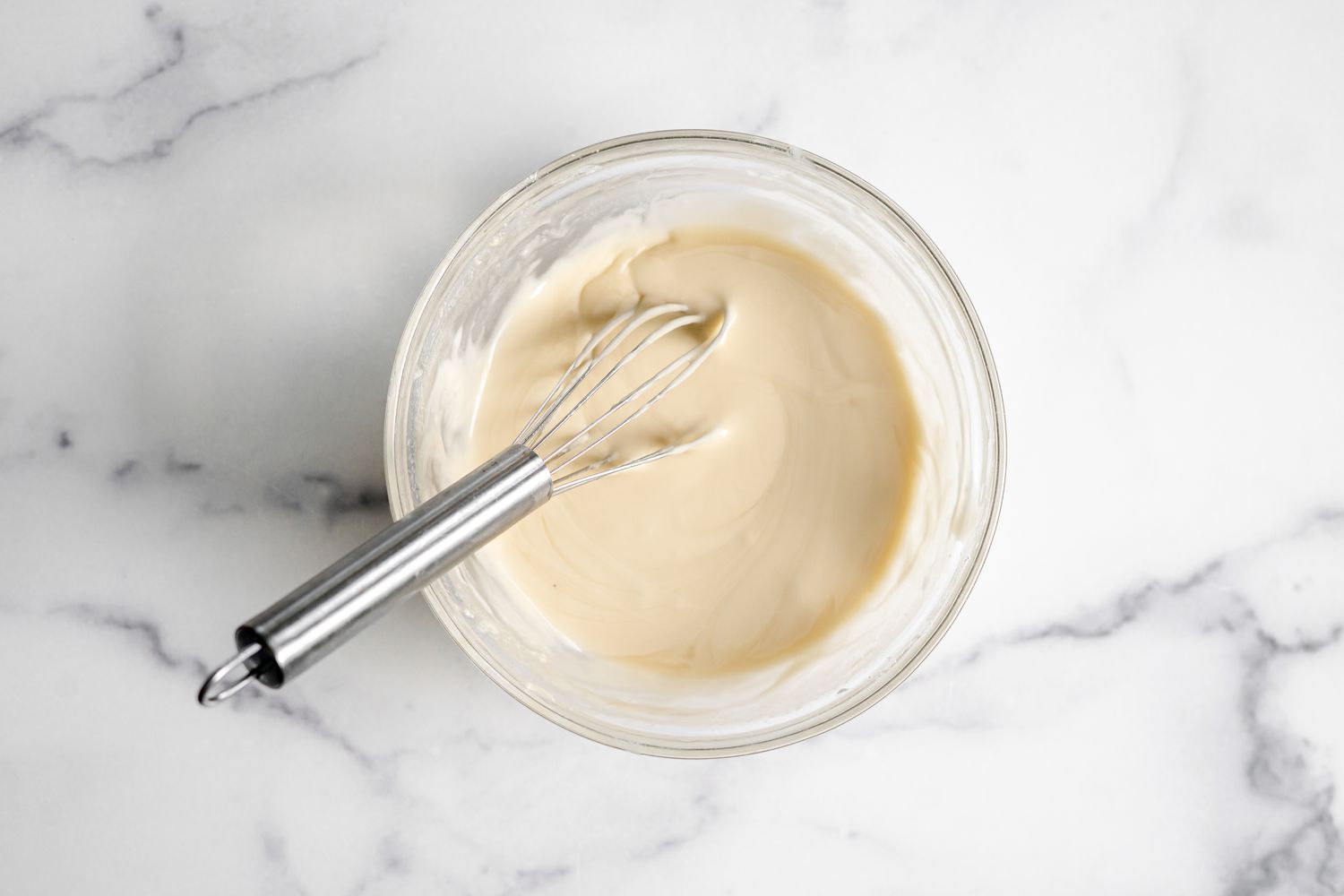 Apple Fritter Bread Glaze in a Bowl with a Whisk