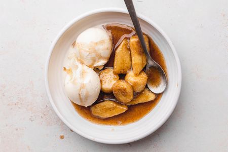 Plate of Bananas Foster with Scoops of Vanilla Ice Cream