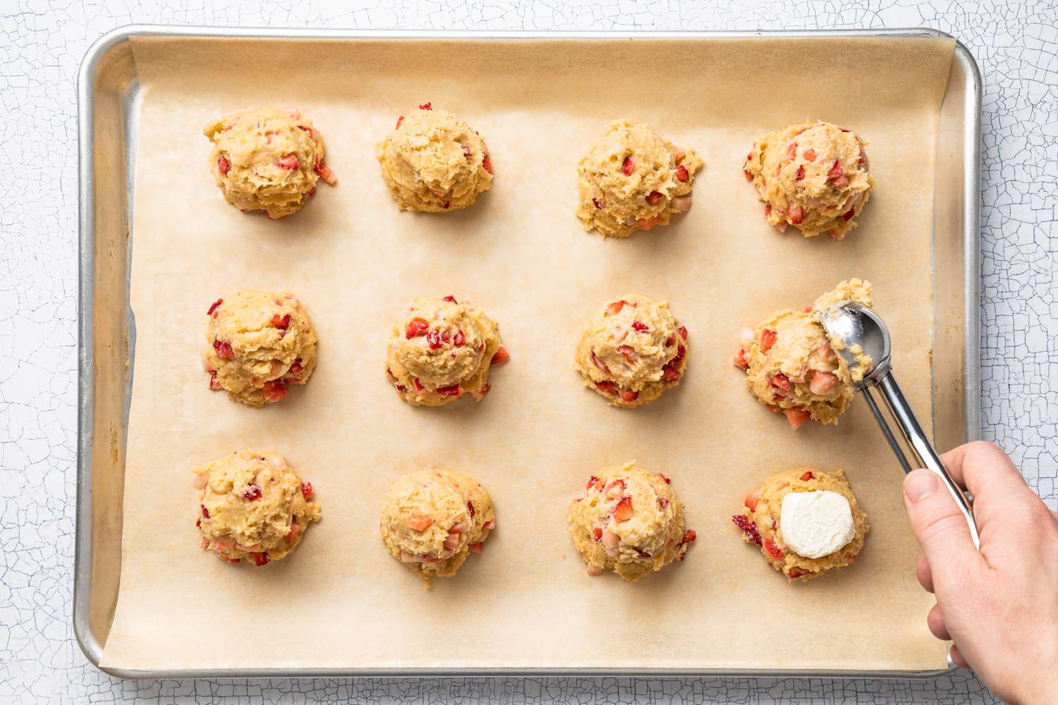 Another scoop of strawberry cookie dough added on top of the cheesecake filling