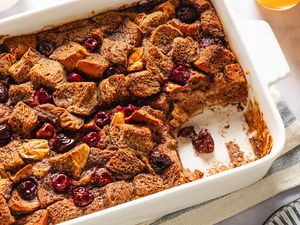 Baked Nutella and cherry French toast in a white dish with some portions missing