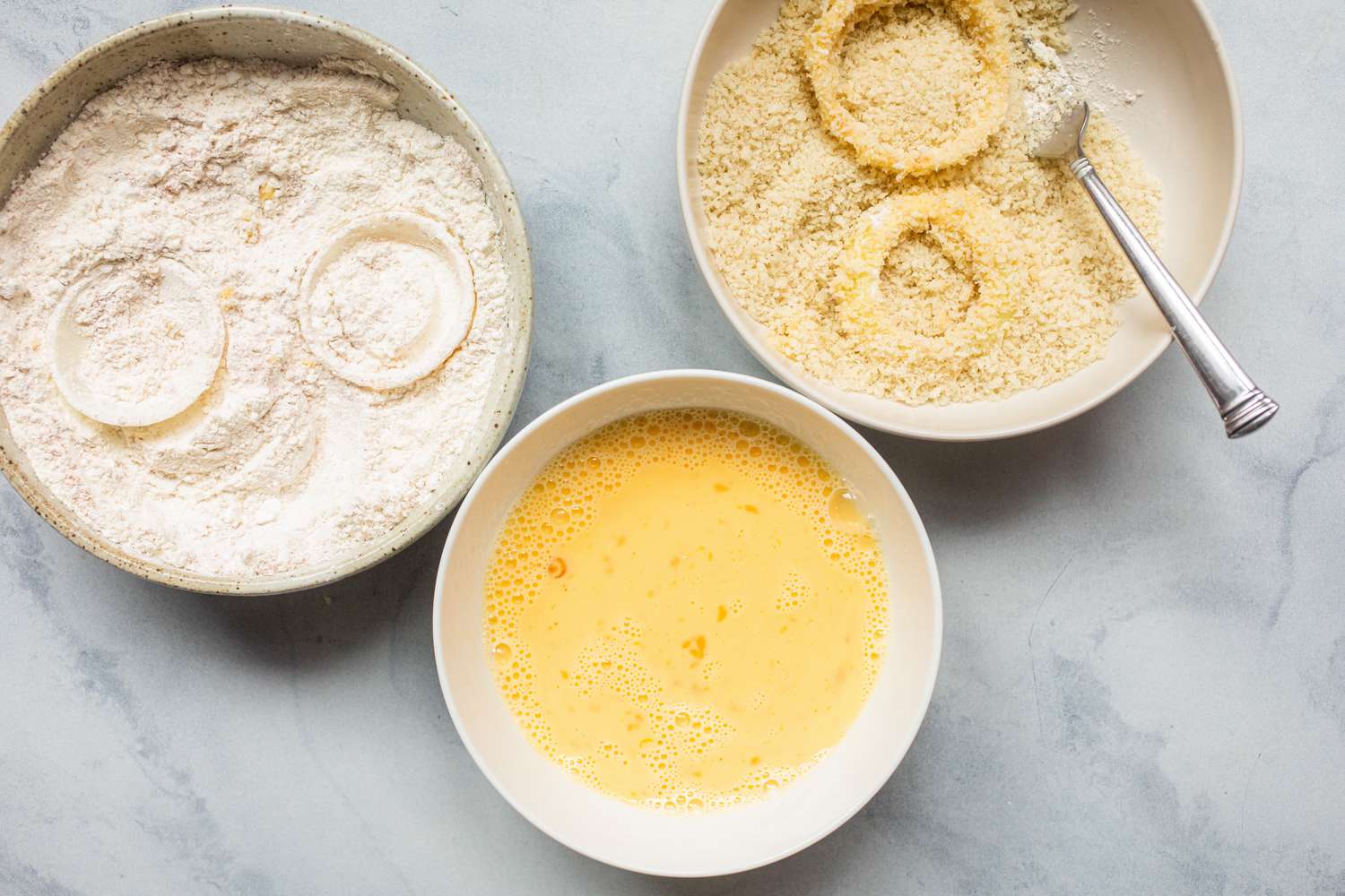 Three bowls for the breading station to make the Best Air Fryer Onion Rings.