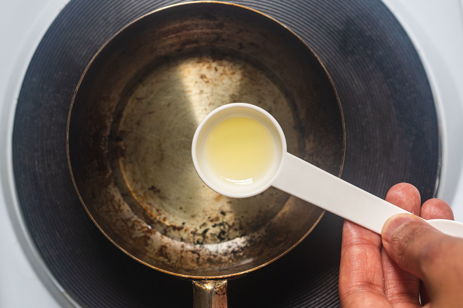 Pouring oil into a skillet