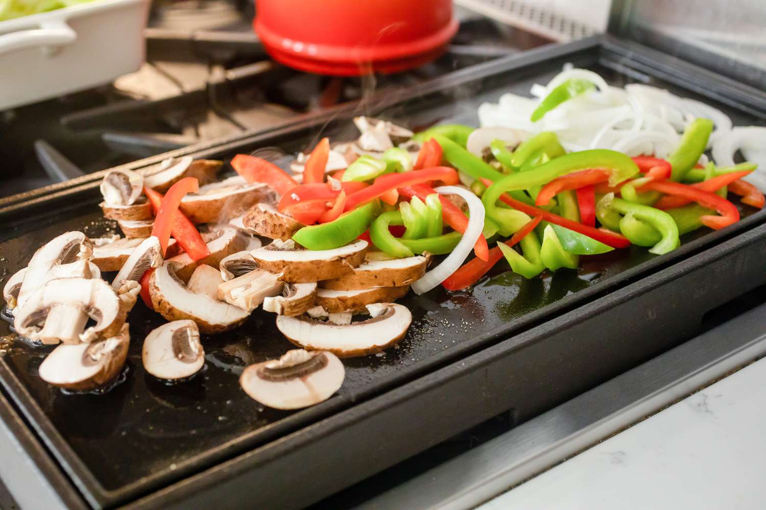 Bell Peppers, Mushrooms, and Onions on Griddle for Philly Cheesesteak Stuffed Peppers