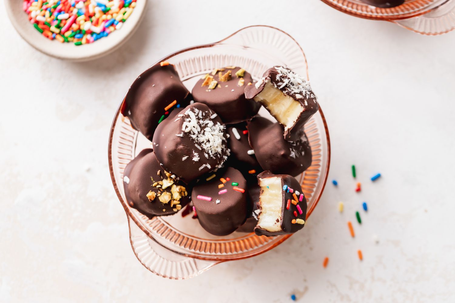 Frozen Chocolate Covered Bananas in a Bowl with Some Pieces Bitten Into