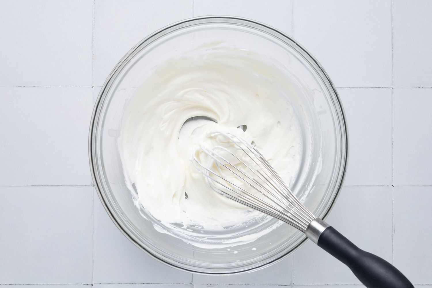 Heavy cream whipped using a hand-held whisk for no-bake pumpkin cheesecake recipe