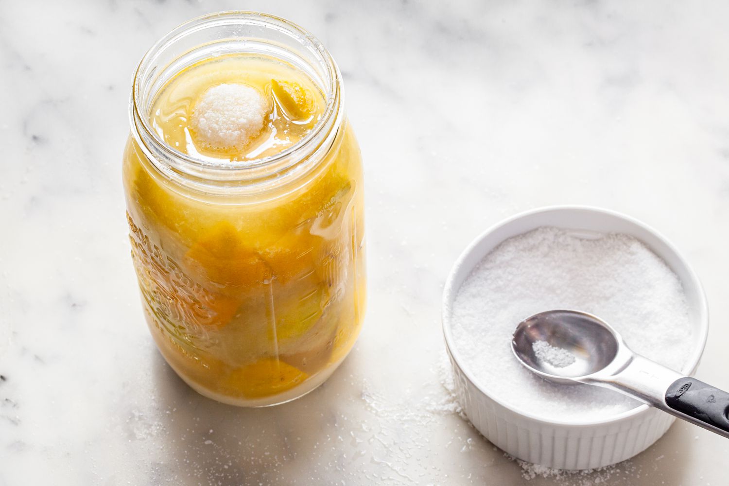 Salt Added to Jar with Lemons for Preserved Lemons Recipe