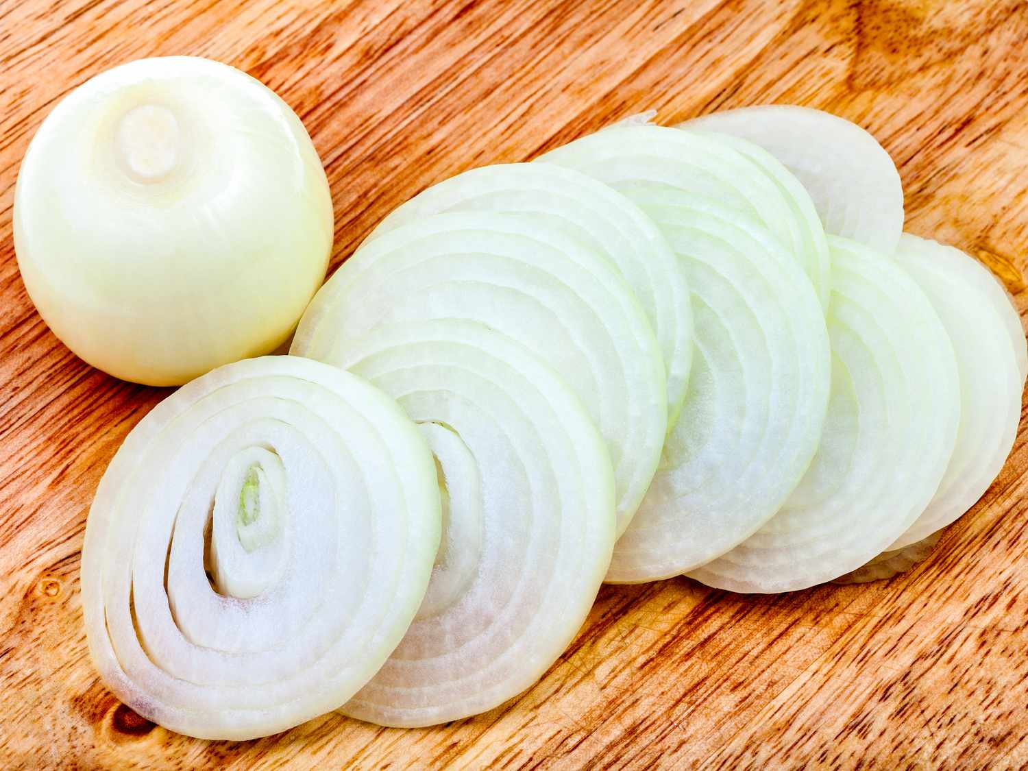 A sliced white onion on a cutting board